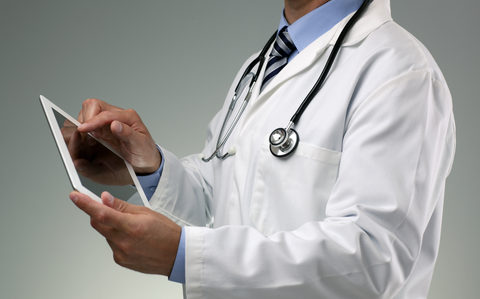 Doctor Viewing Patient Registry Data on Table Doctor Patient Registry Tablet